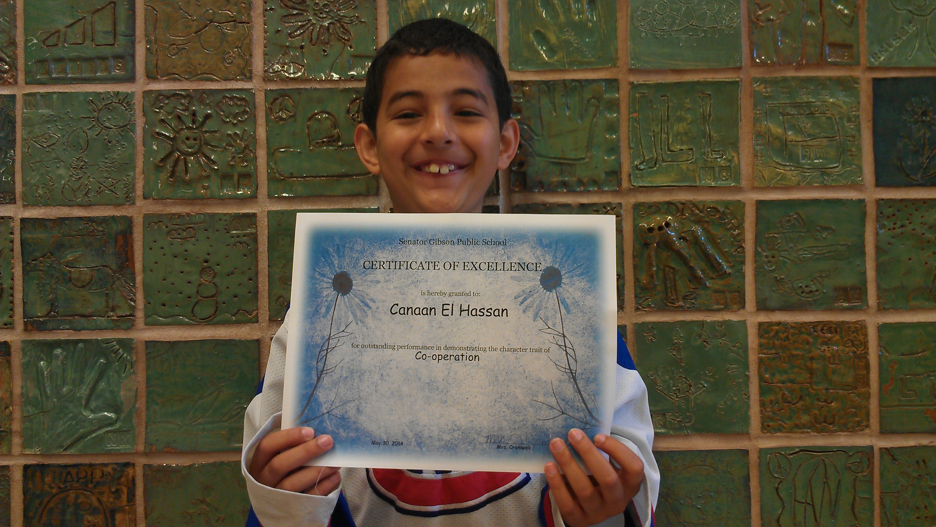 Receiving a Certificate of Excellence at Senator Gibson Public School.